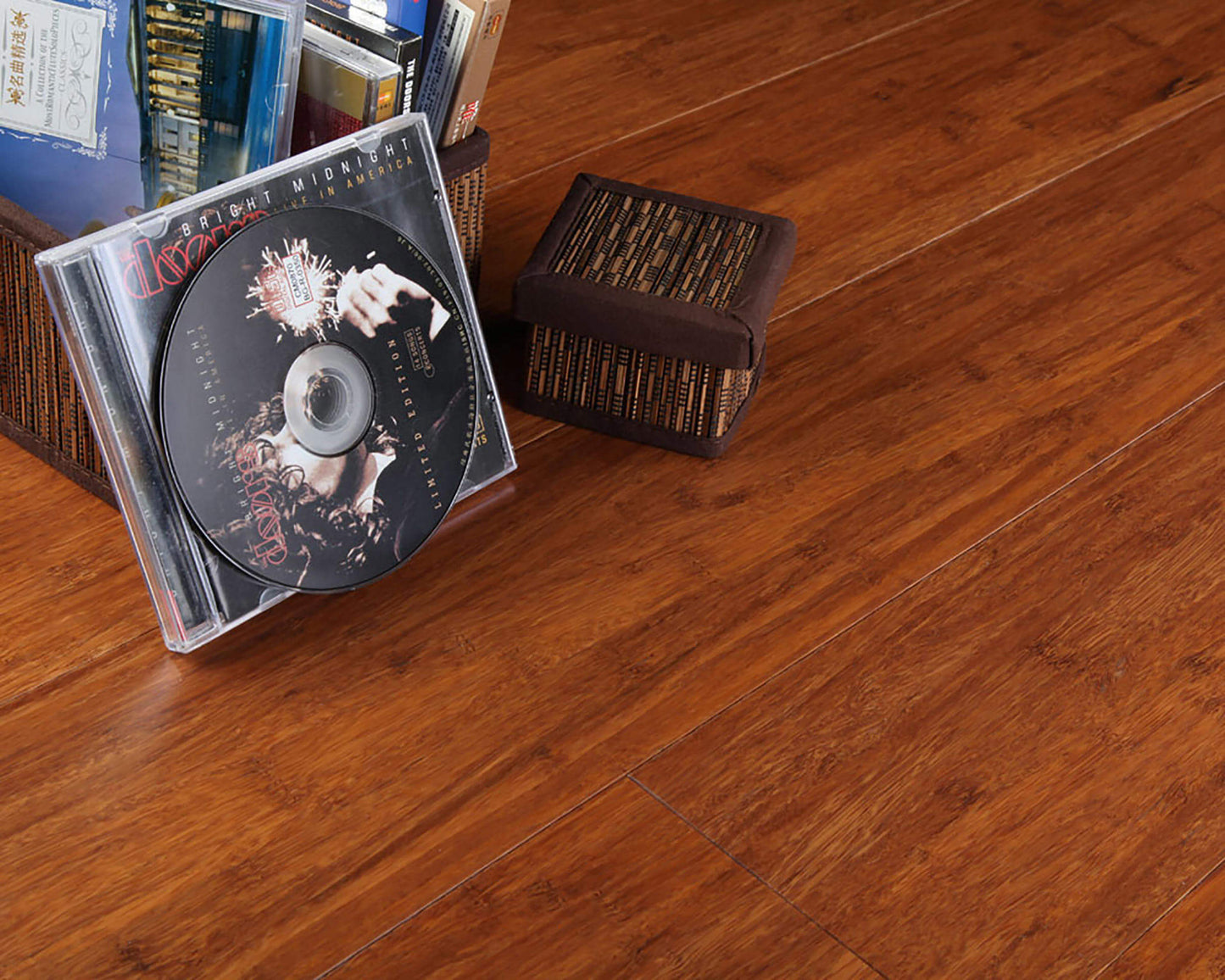 CD and case on a wooden surface with a woven basket in the background