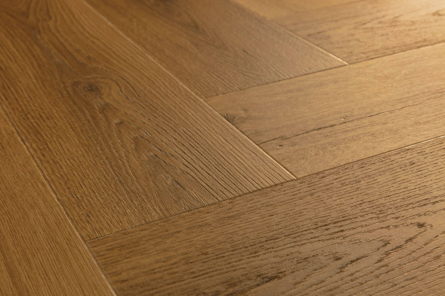 Close-up of a wooden floor with a herringbone pattern