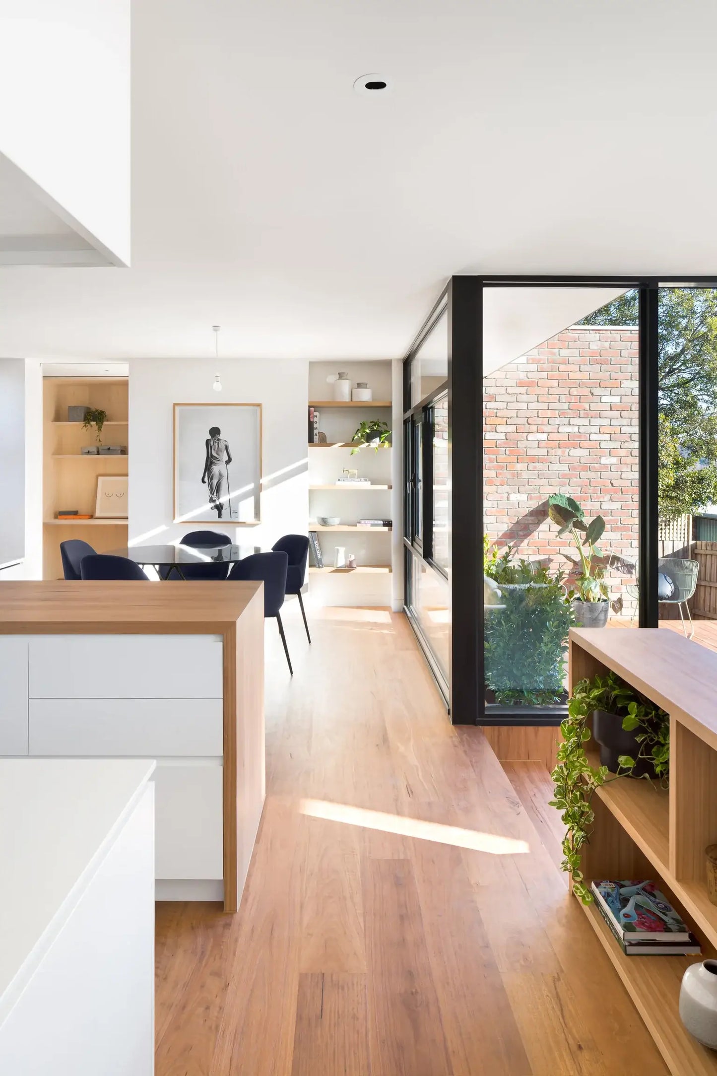 Modern kitchen with wooden floor and large windows