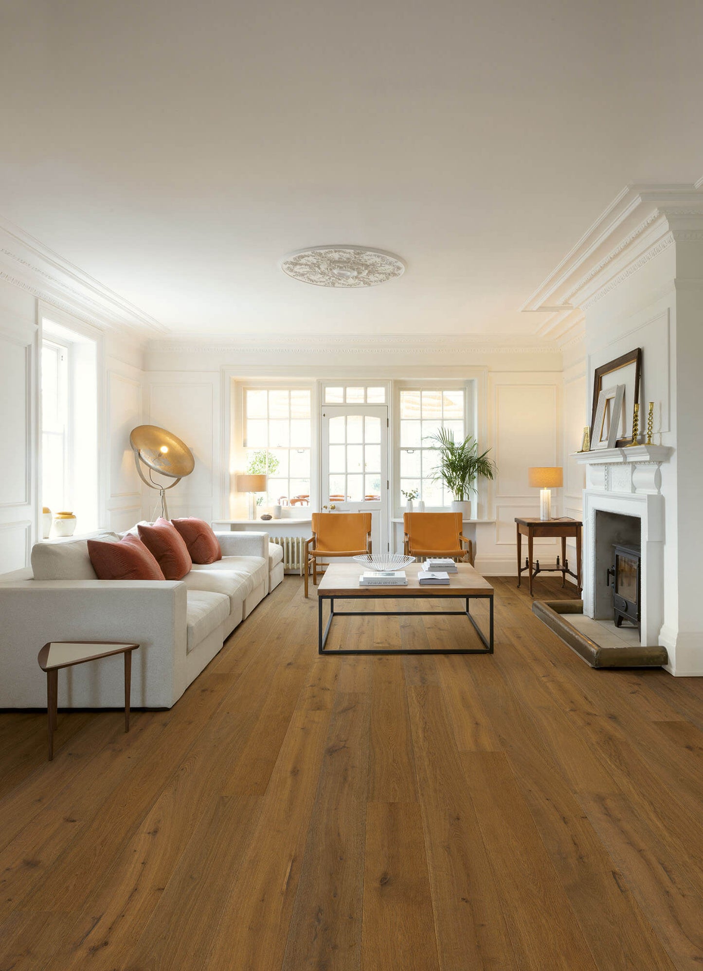 Living room with wooden floor, white walls, and modern decor.