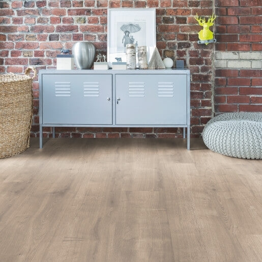 Light blue cabinet against a brick wall with decorative items on top