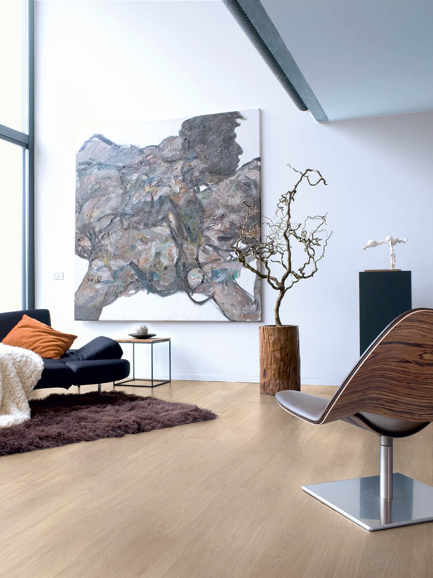 Modern living room with a large abstract painting, a chair, and a plant.