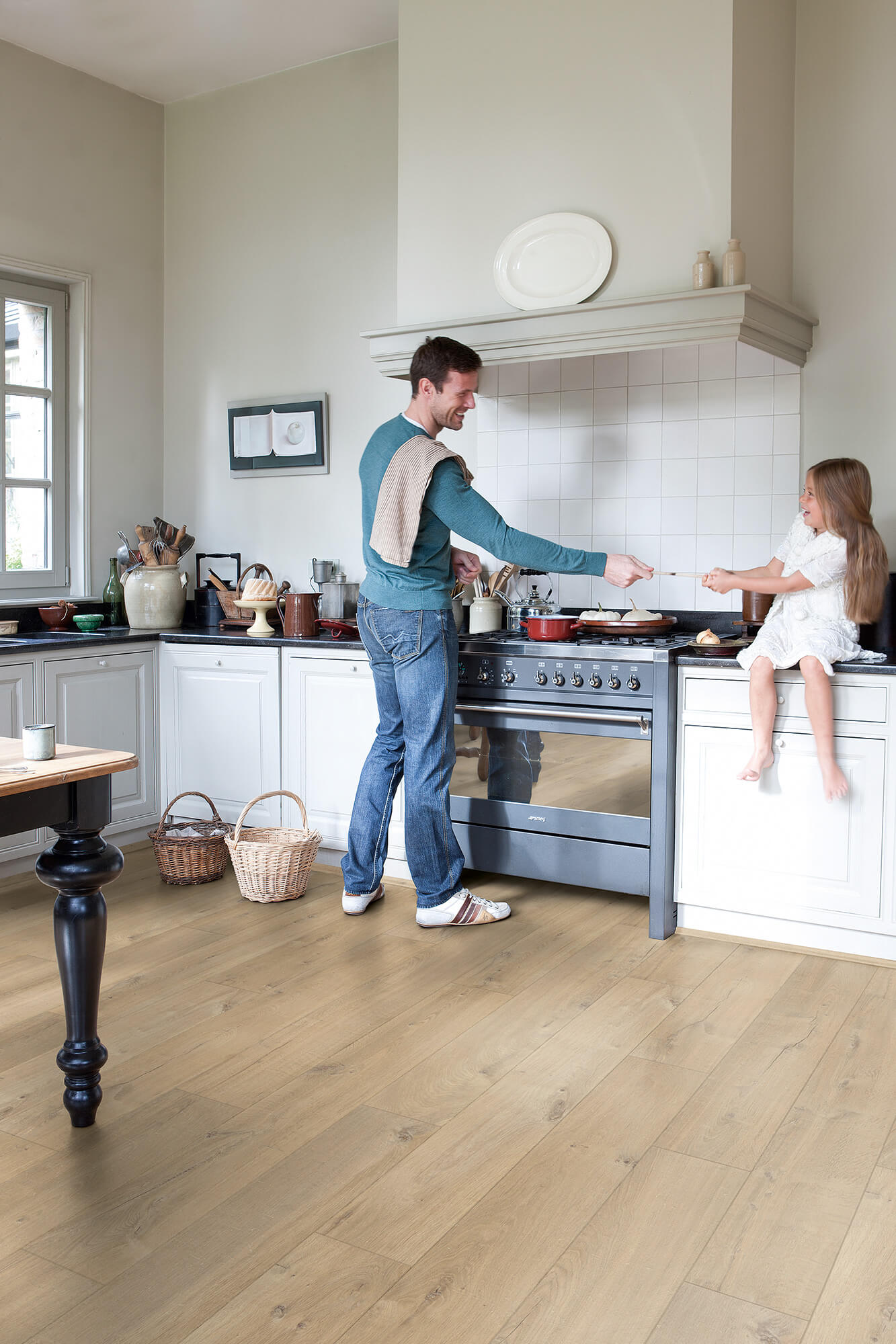 Man and child in a kitchen preparing food together.