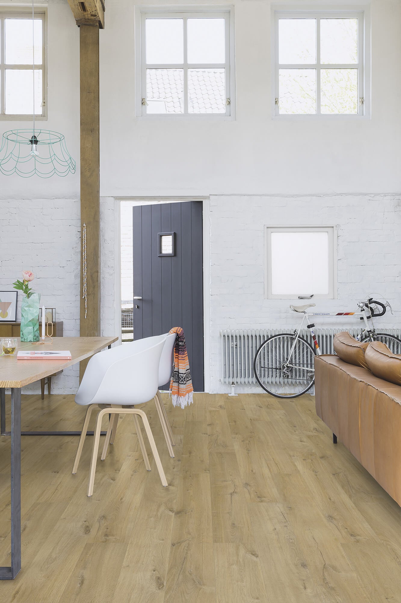 Modern interior with wooden floor, white walls, and a bicycle.