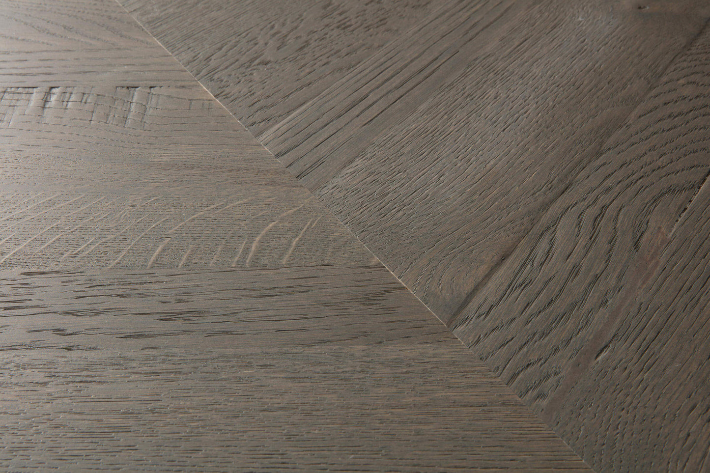 Close-up of wooden flooring with a herringbone pattern