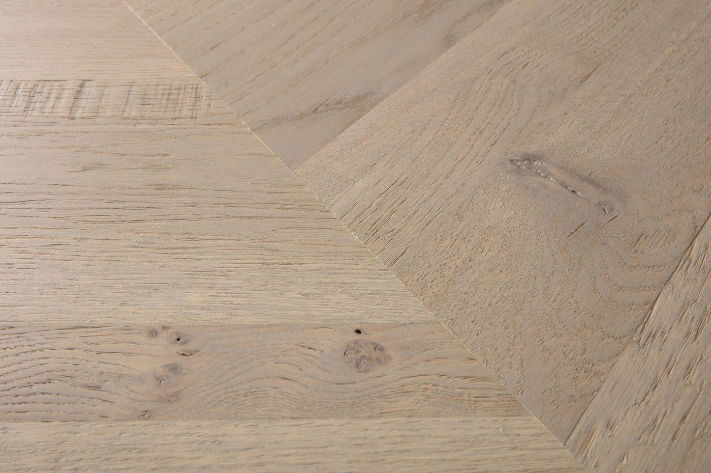 Close-up of wooden flooring with a herringbone pattern