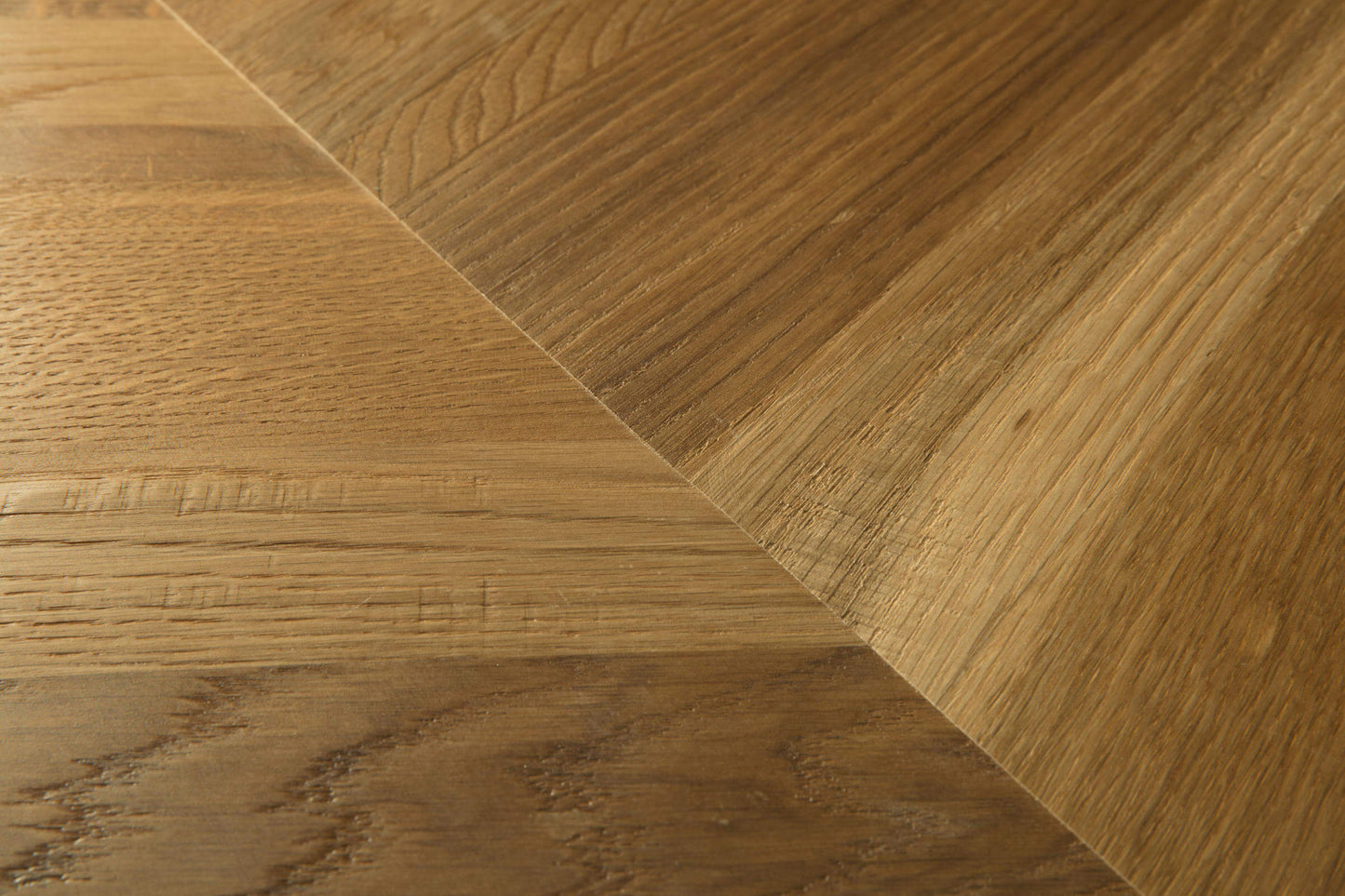 Close-up of wooden flooring with a herringbone pattern