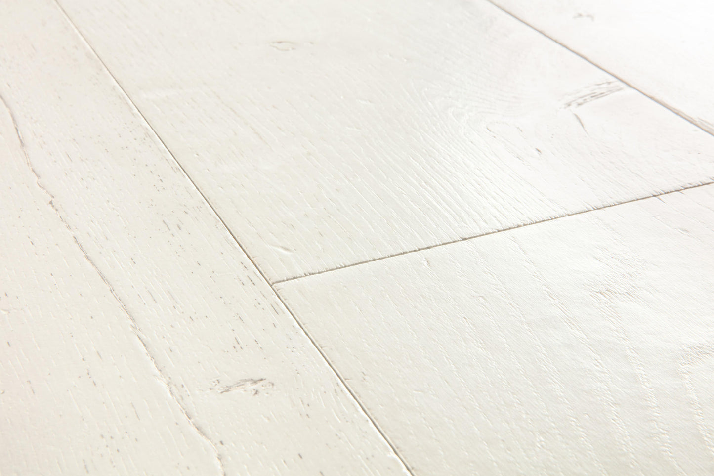 Close-up of white wooden flooring with a herringbone pattern