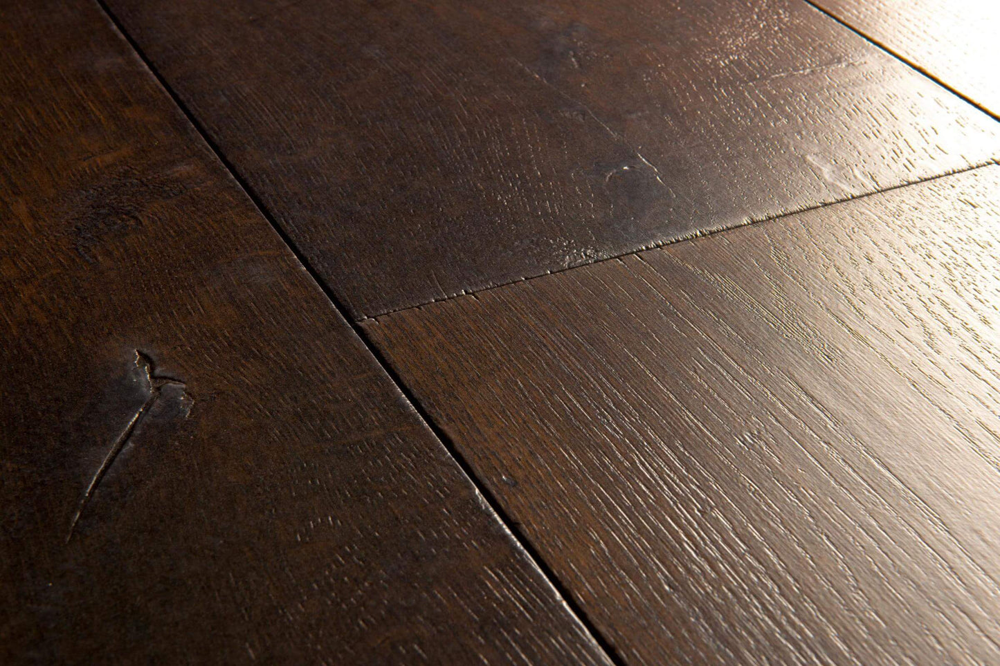 Close-up of dark wooden flooring with visible grain and texture.