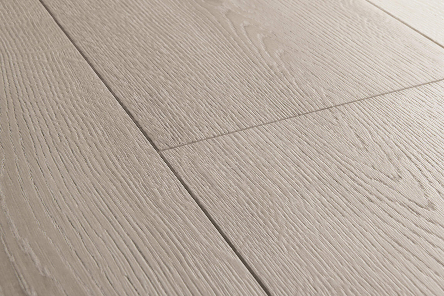 Close-up of gray wooden flooring with a visible grain pattern.