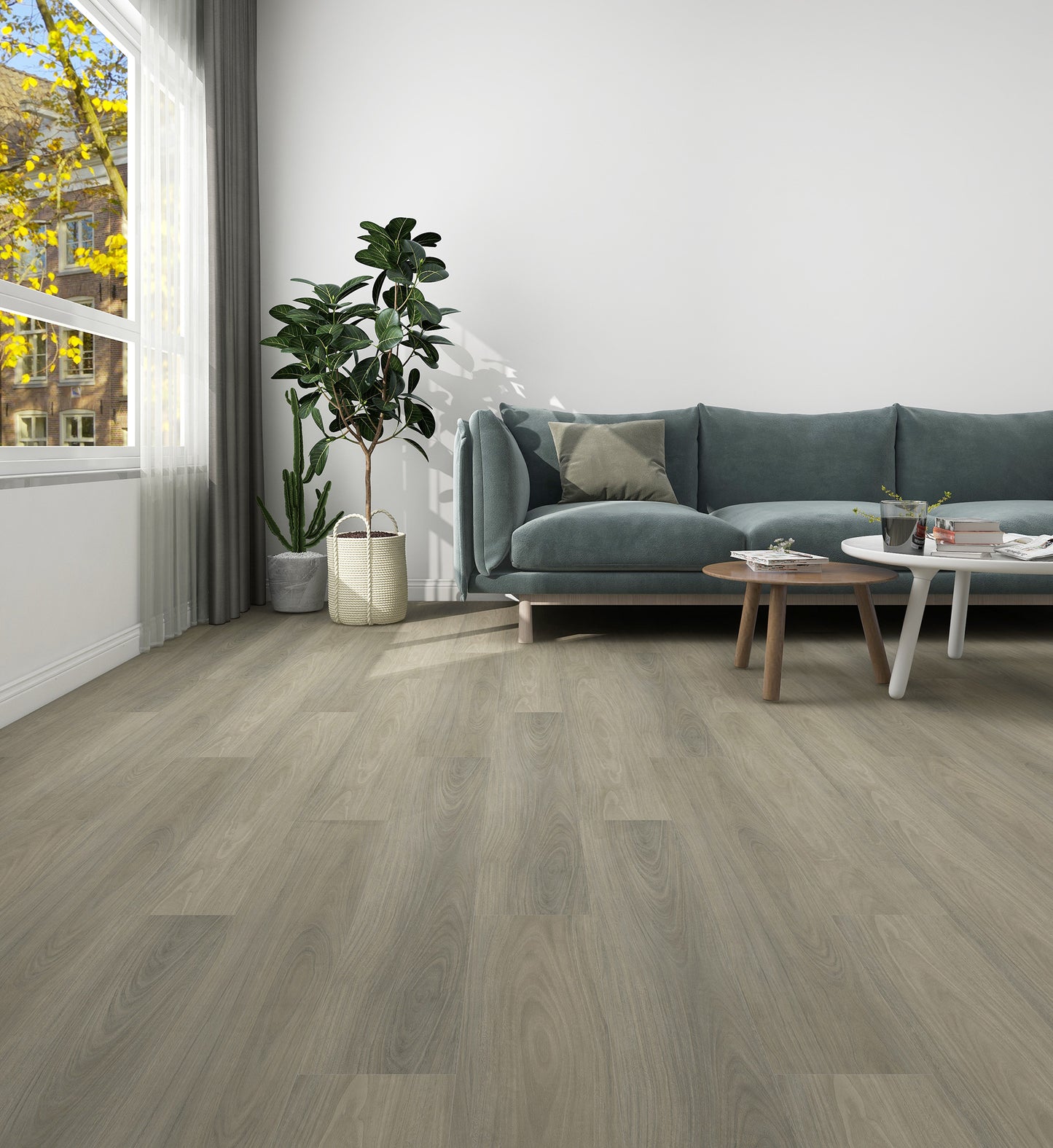 Living room with a gray sofa, coffee table, and decorative items on a wooden floor.