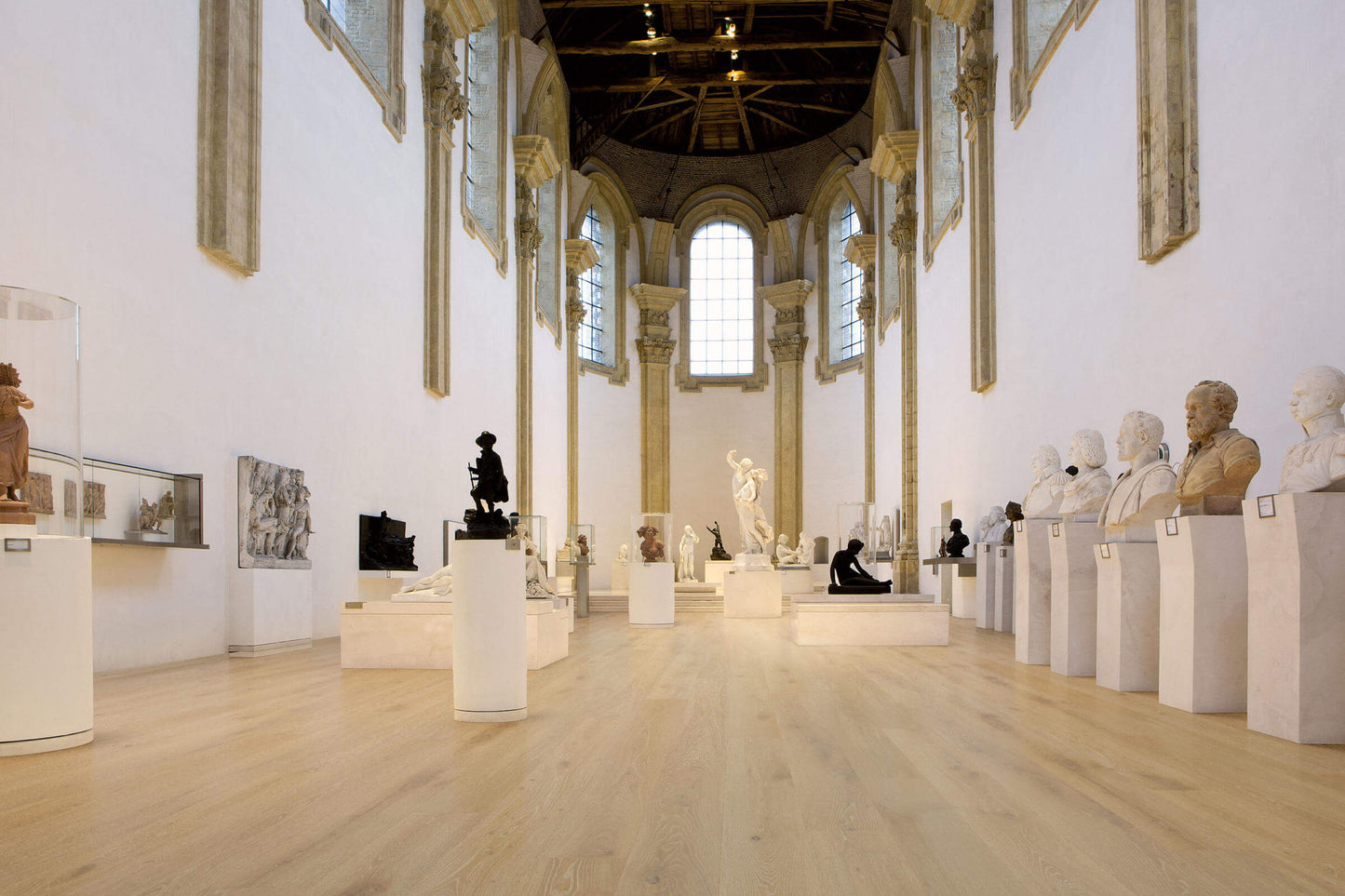 Museum gallery with classical sculptures on pedestals