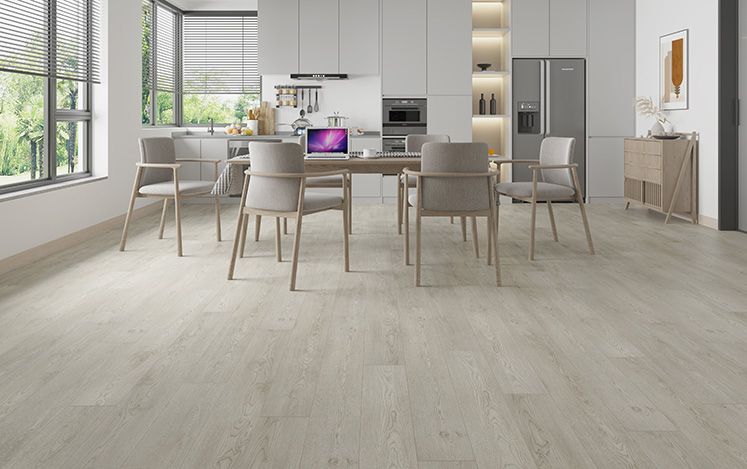 Modern kitchen with a dining area featuring a table and chairs.
