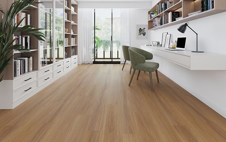 Modern home office with wooden floor, bookshelves, and desk.