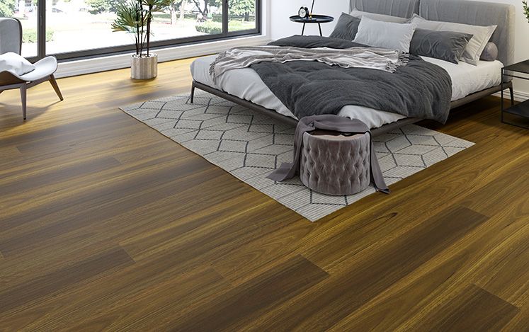 Modern bedroom with wooden flooring, bed, and decorative items.