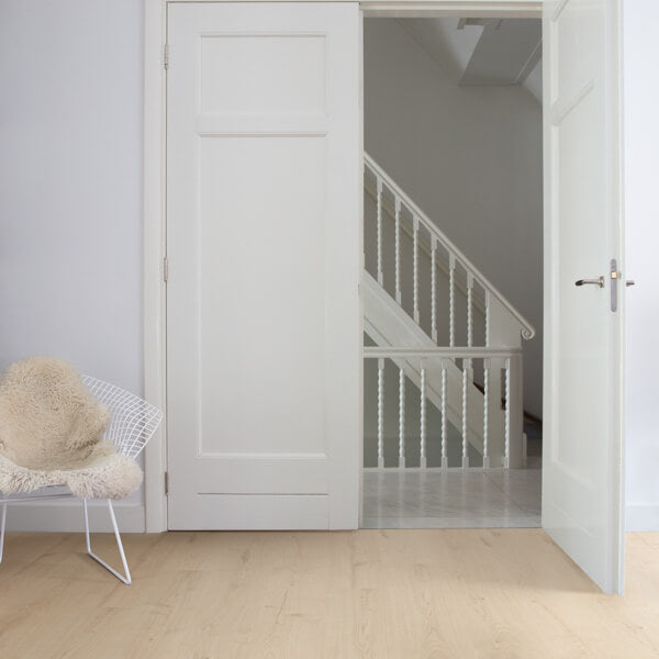 White door with a chair and staircase in the background