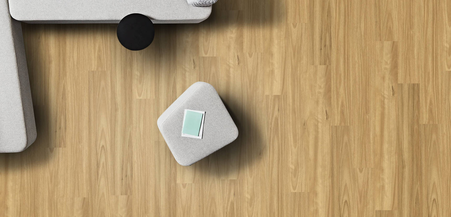 Small gray electronic device on a wooden floor