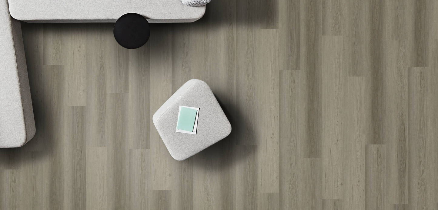 Small white square object with a green label on a wooden surface