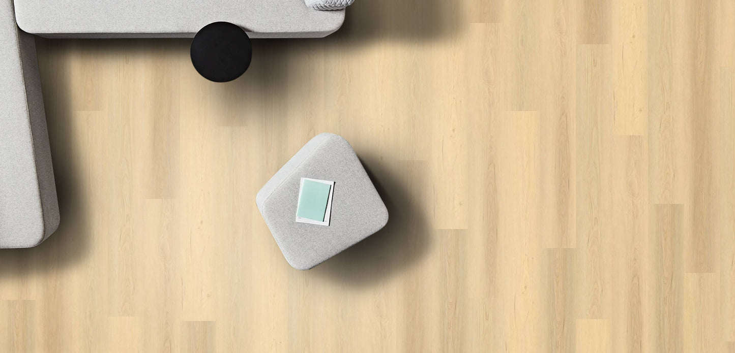 Small gray cube with a green label on a wooden surface