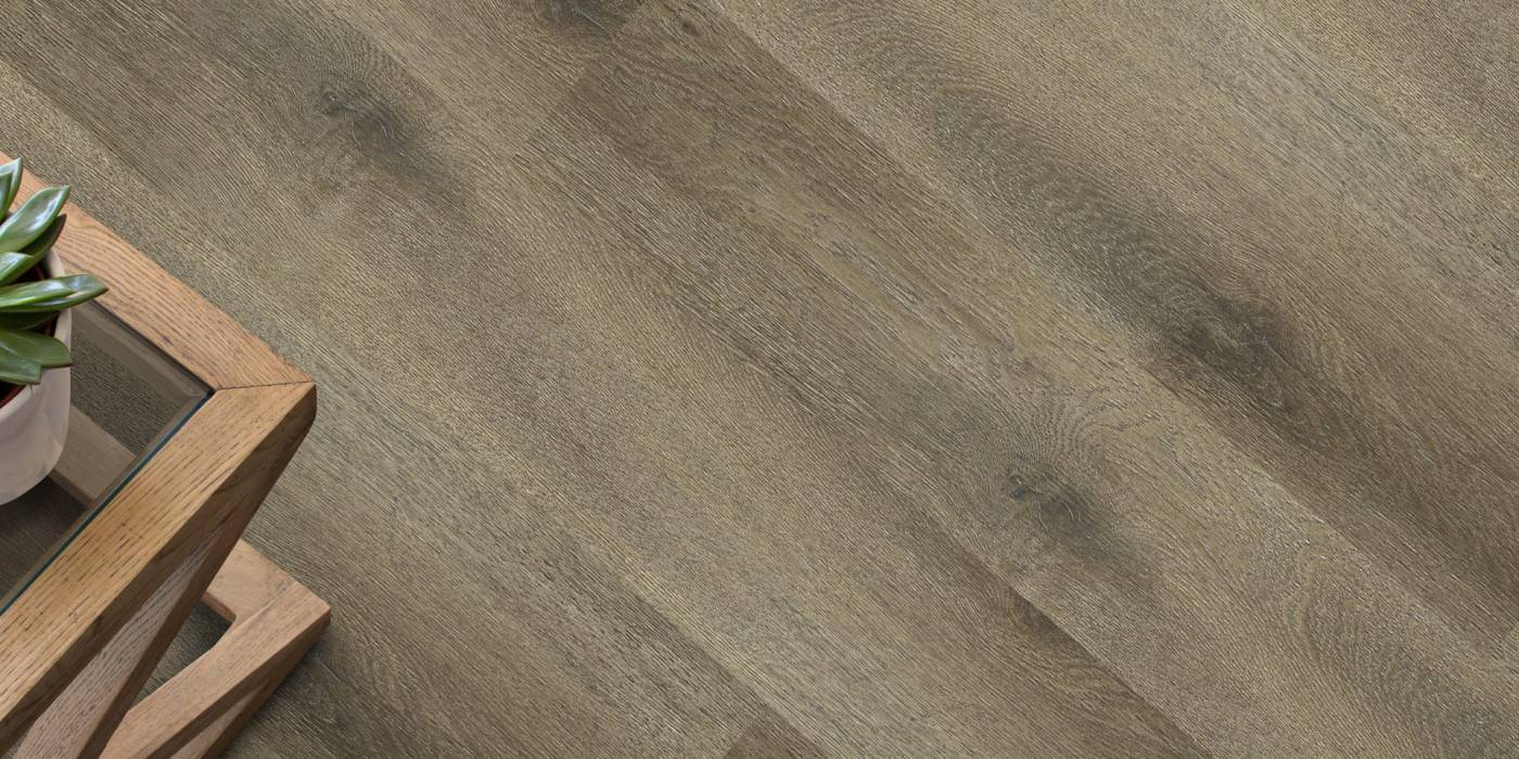 Wooden floor with a wooden table and plant in the corner