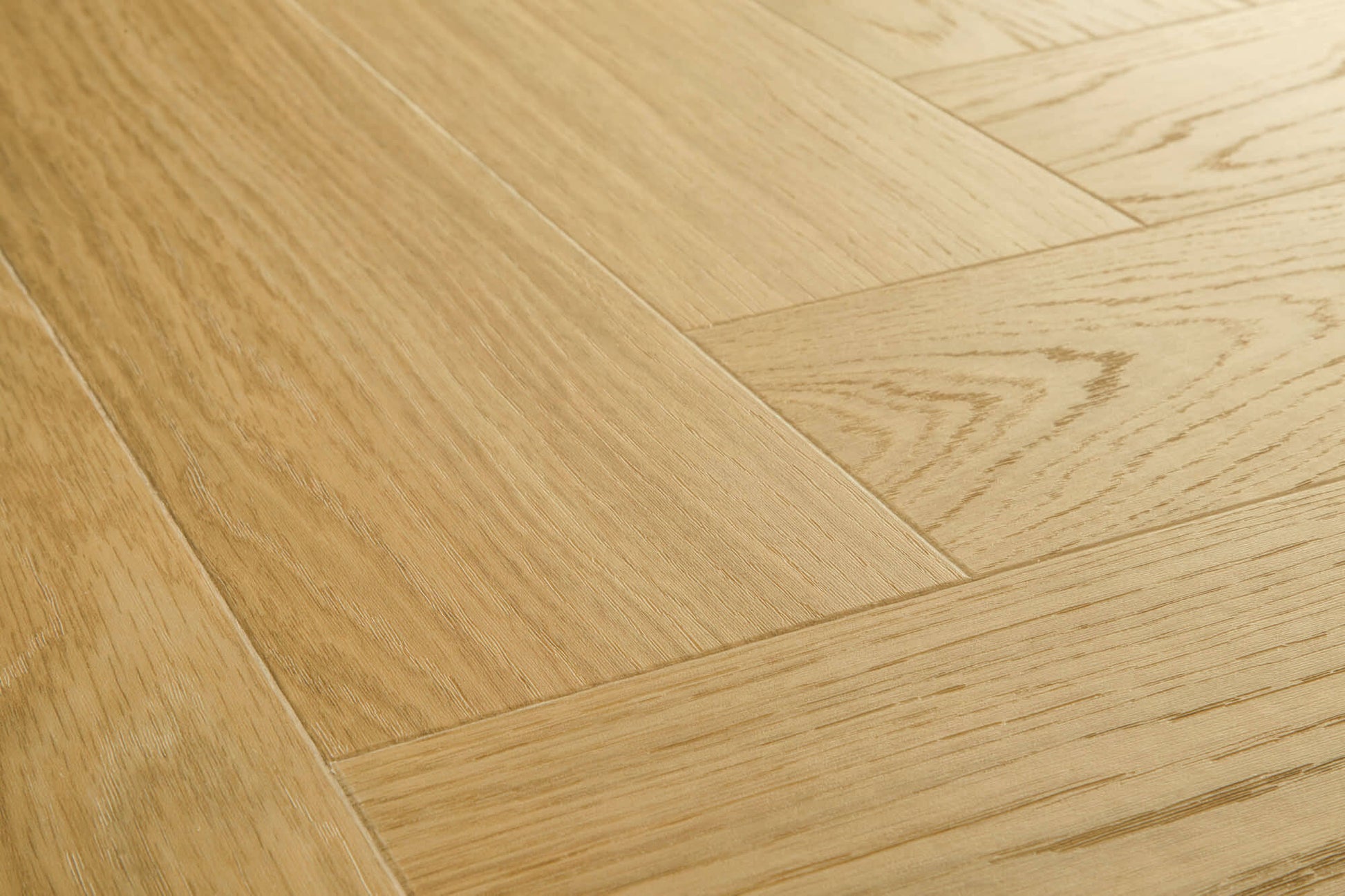 Close-up of a wooden floor with a herringbone pattern