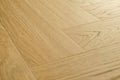 Close-up of a wooden floor with a herringbone pattern