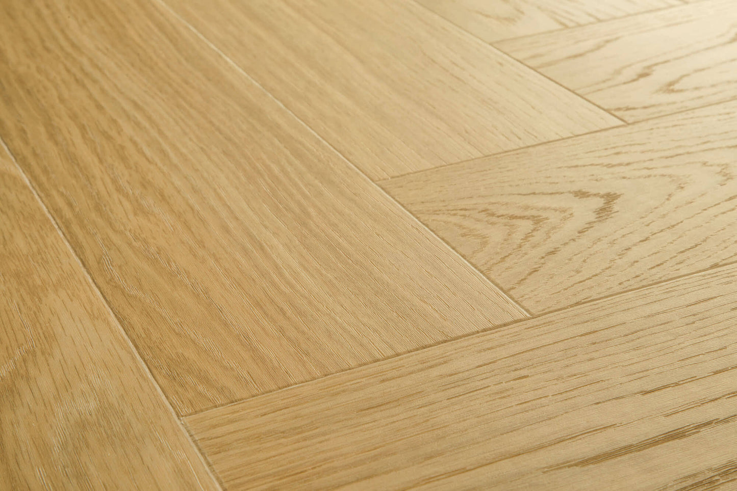 Close-up of a wooden floor with a herringbone pattern