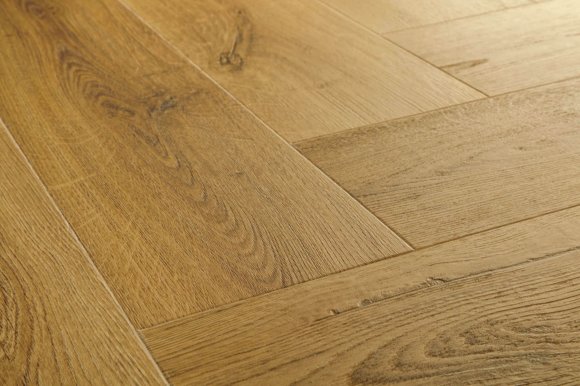 Close-up of wooden flooring with a herringbone pattern