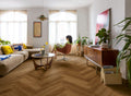 Living room with a woman sitting on a chair, plants, and a large TV.