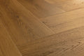 Close-up of a wooden floor with a herringbone pattern