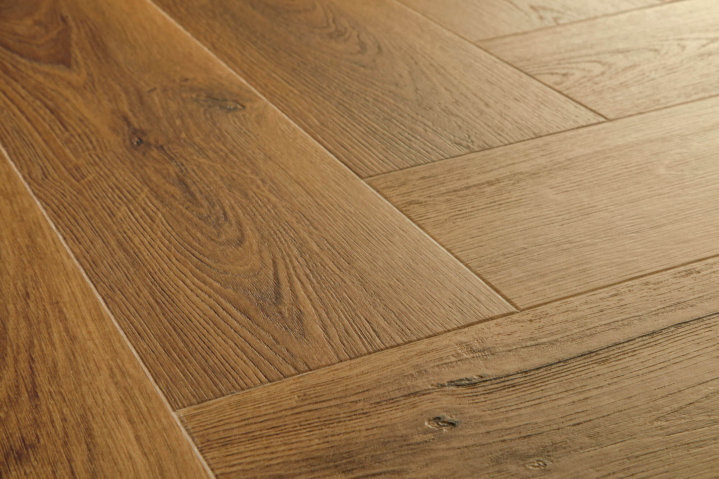 Close-up of wooden flooring with a herringbone pattern