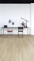 Modern office setup with a desk, chairs, and decor on a light wood floor.