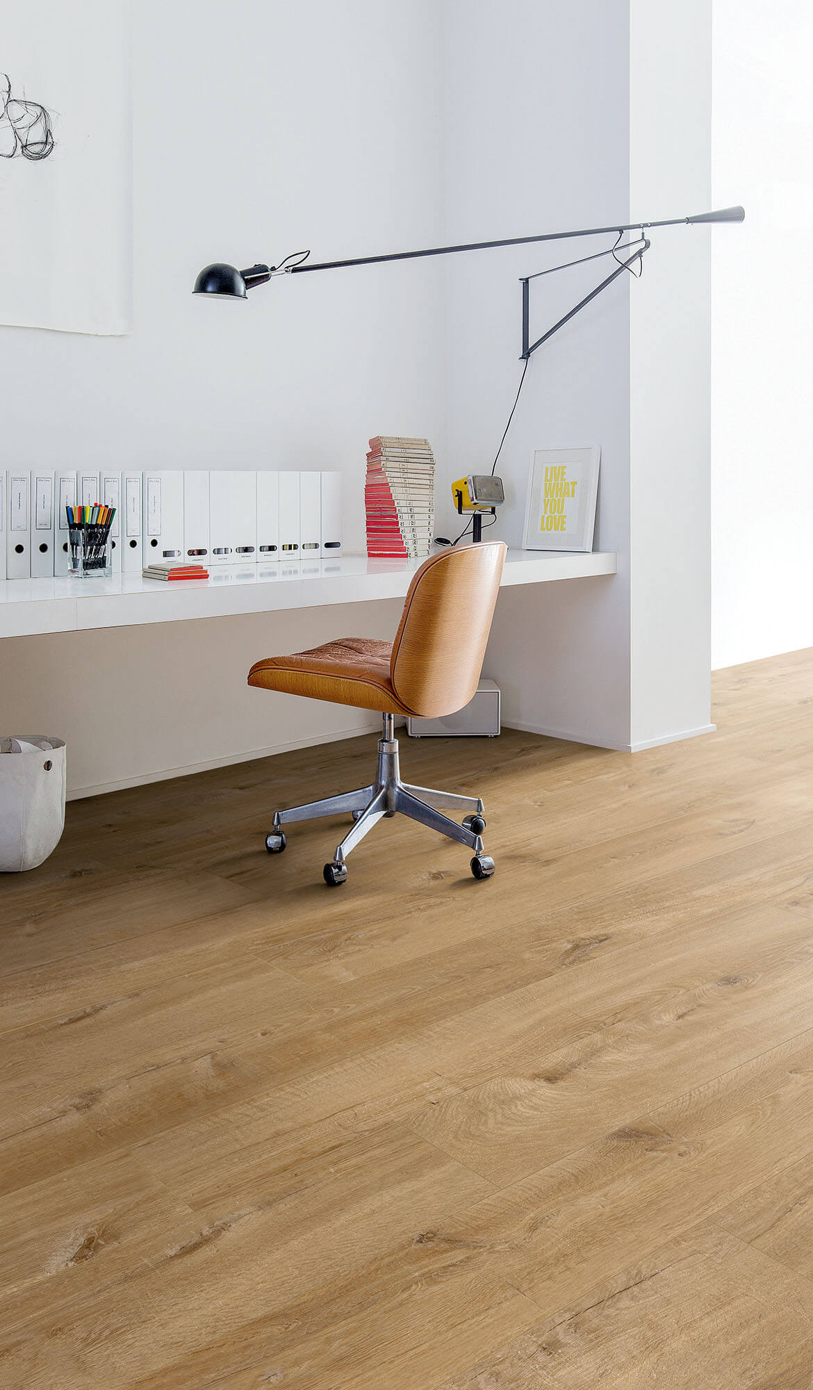 Modern office setup with a wooden chair, desk, and lamp.