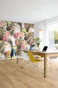 Modern office with colorful floral wall mural, wooden desk, and colorful chairs.
