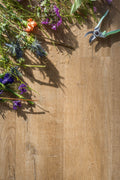 Floral arrangement and garden shears on a wooden surface