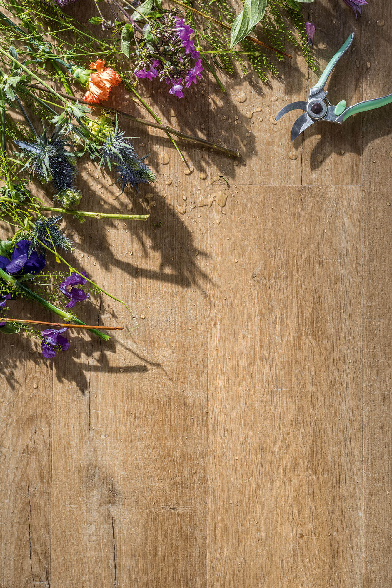Floral arrangement and garden shears on a wooden surface