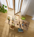 Dining area with a wooden table and chairs in a bright room with large windows.