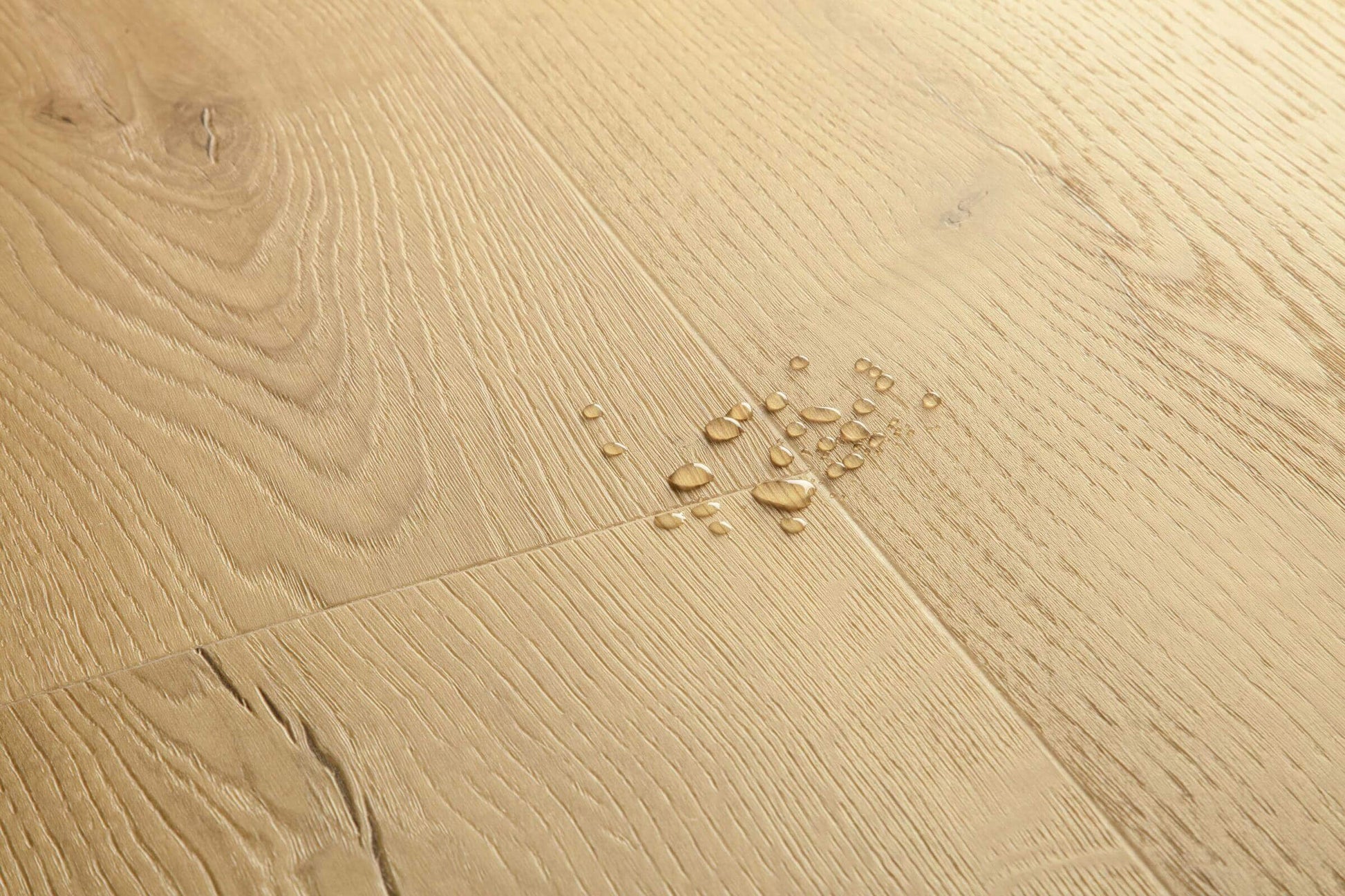 Close-up of a wooden floor with water droplets on it