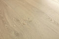 Close-up of a beige wooden surface with visible grain and texture