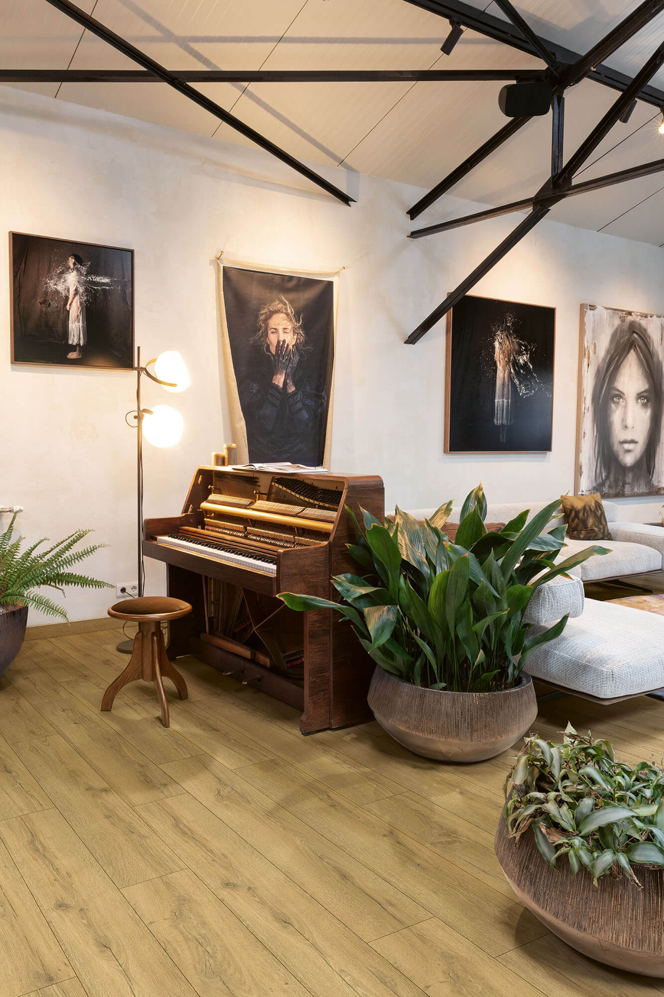 Living room with a piano, plants, and wall art
