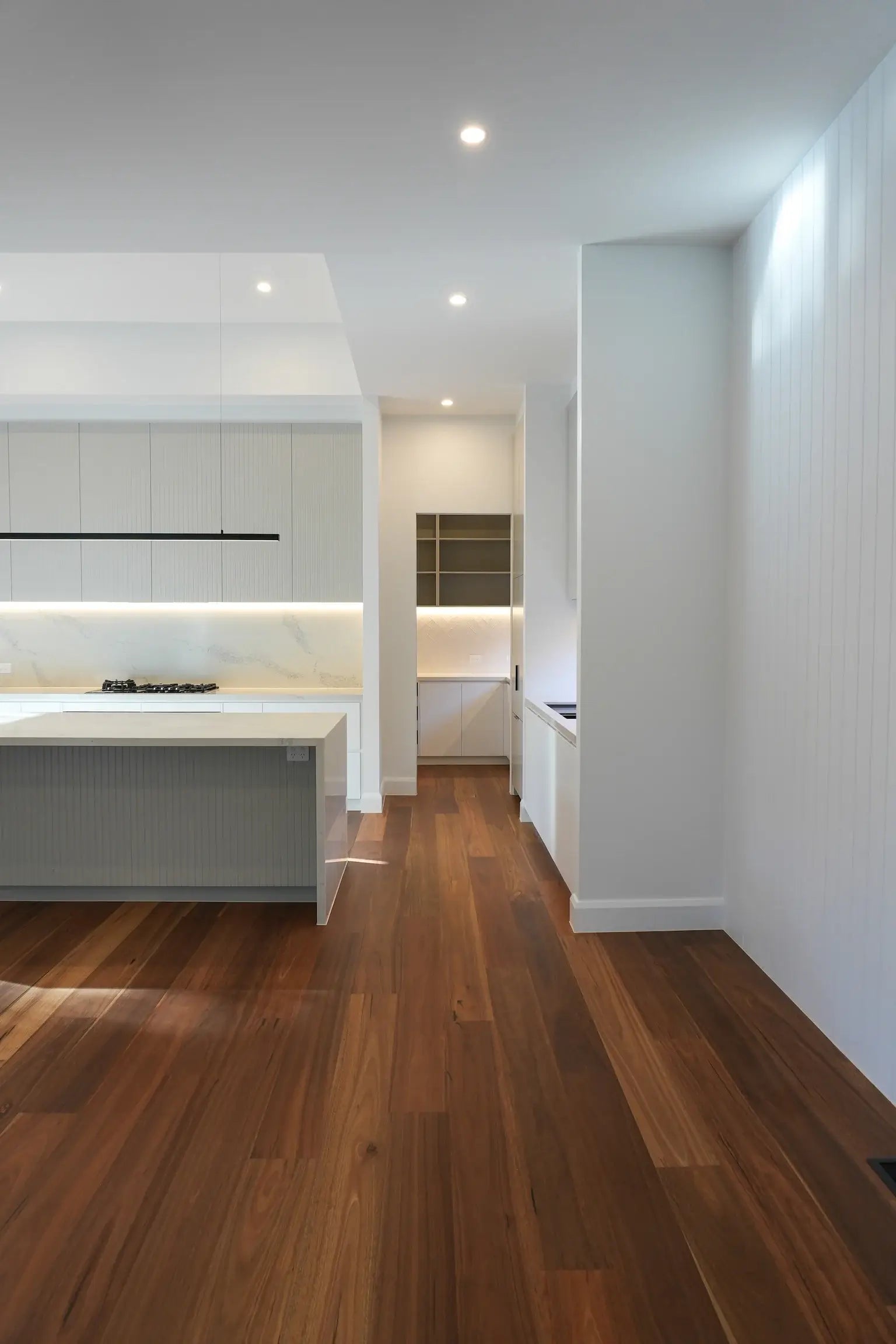 Modern kitchen with wooden floor and white walls