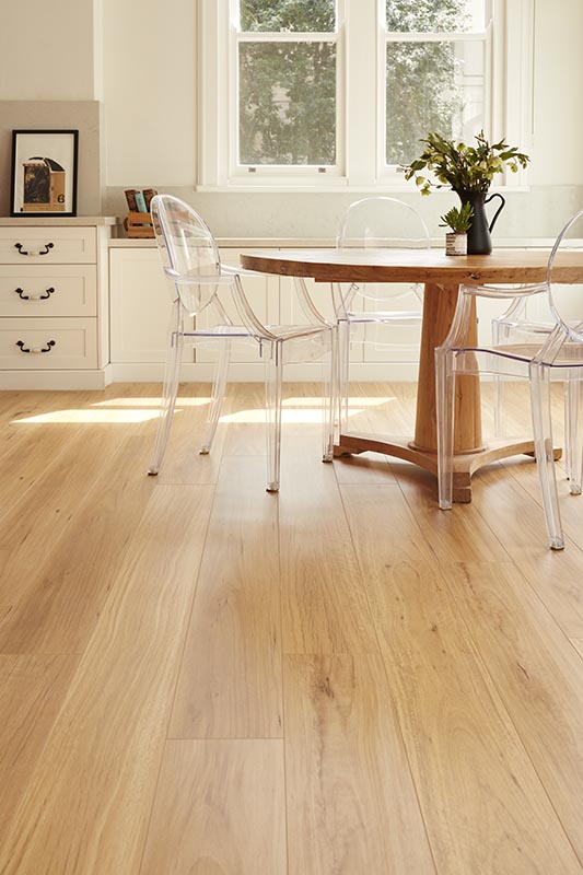 Dining room with wooden floor, table, and chairs.