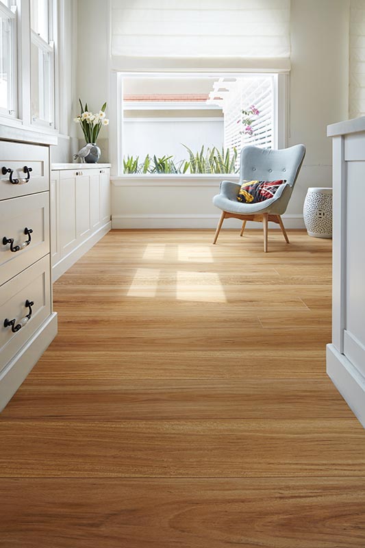 Wooden floor in a room with white walls and furniture.