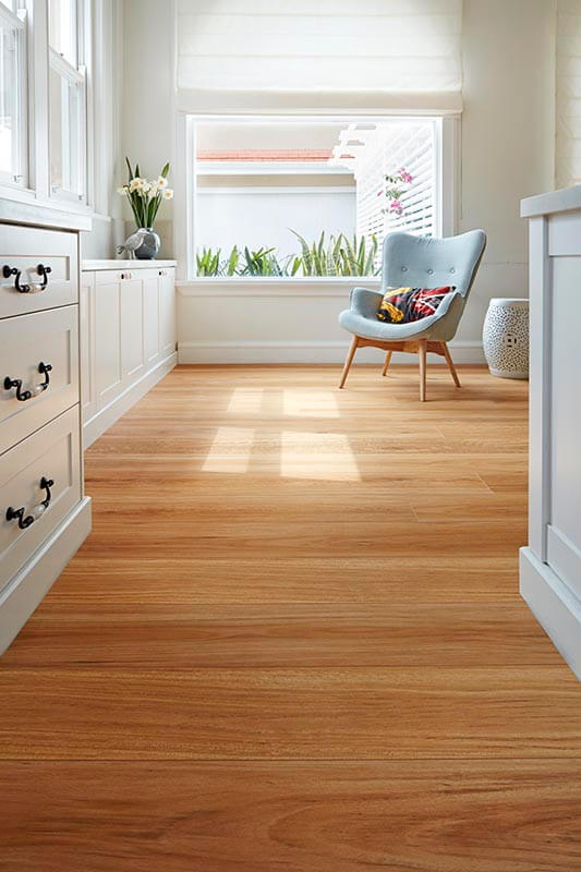 Wooden floor in a room with white walls and furniture