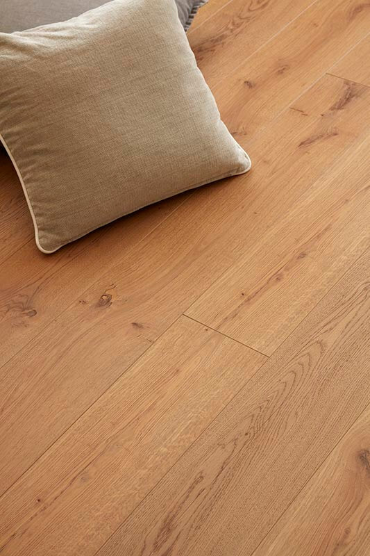 Wooden floor with a beige cushion on top