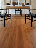 Wooden flooring with a dining table and chairs in the background