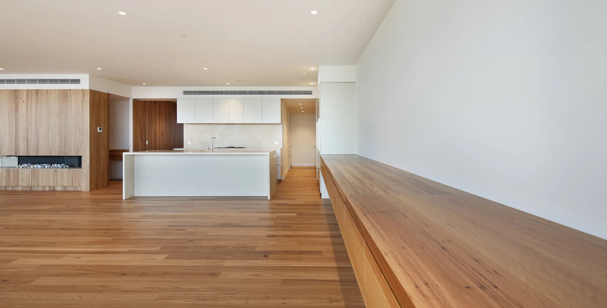 Modern kitchen with wooden floor and white walls