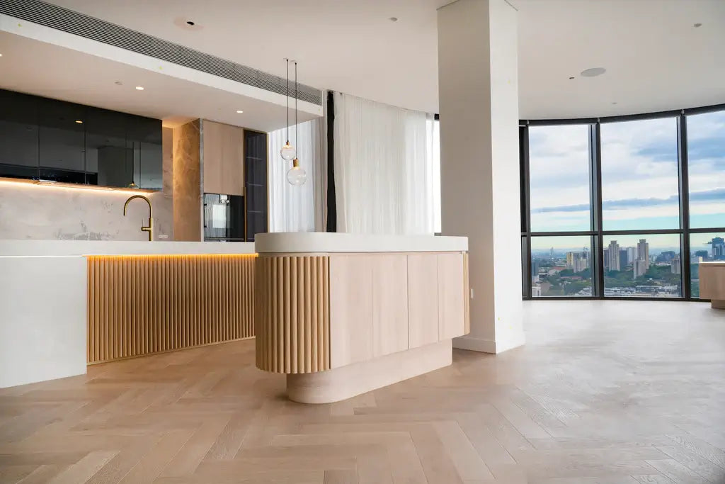 Modern kitchen with a large island and cityscape view