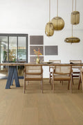 Dining area with wooden table and chairs, modern pendant lights, and a neutral color scheme.
