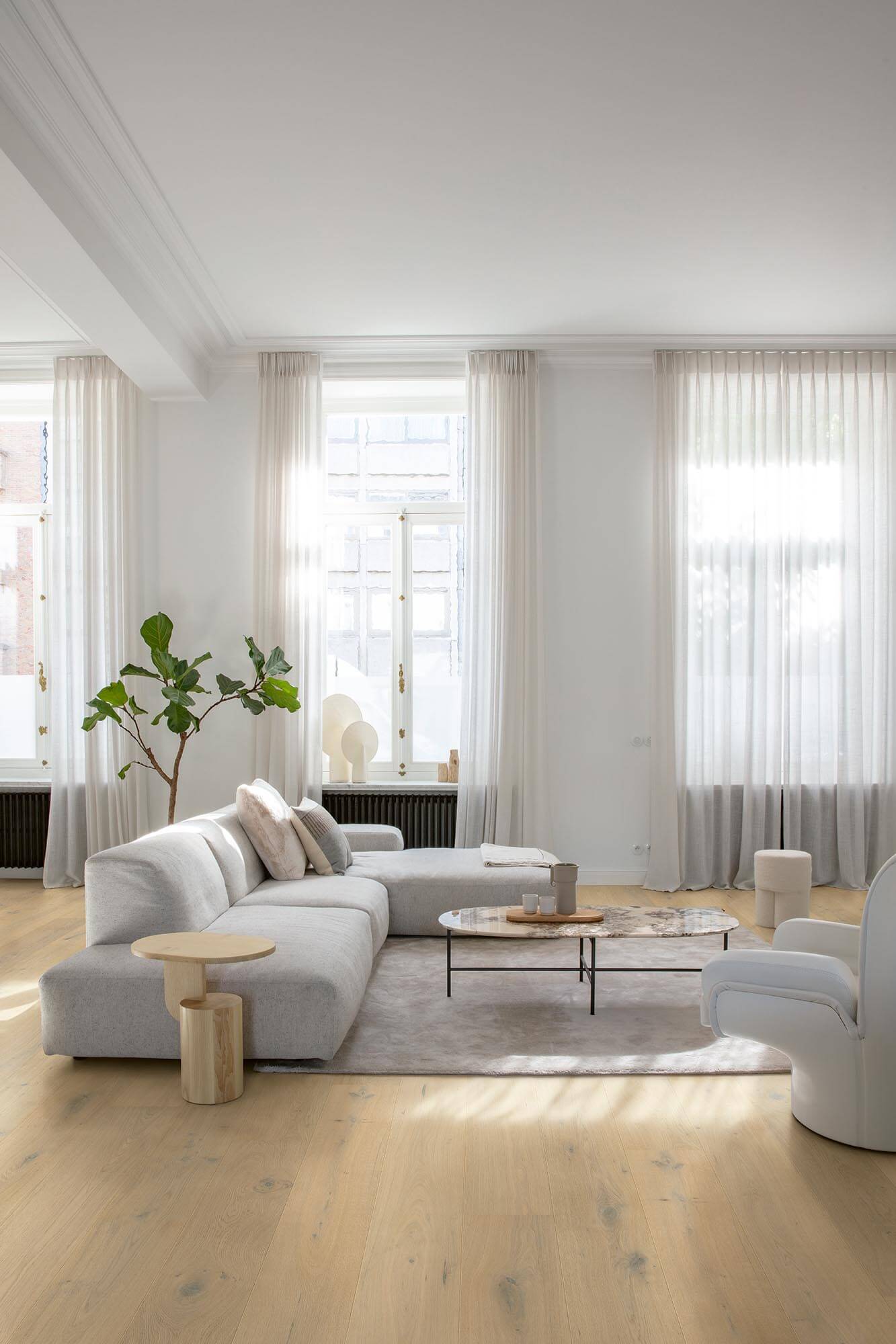 Modern living room with a gray sofa, coffee table, and decorative items.